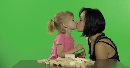 Mother and daughter plays the jenga and making a kiss