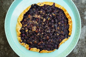 Homemade rustic galette pastry with fresh blueberries and ground almonds