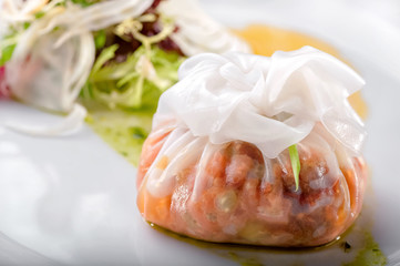 steamed stuffed dim sum from rice dough close-up and fresh salad on white plate 