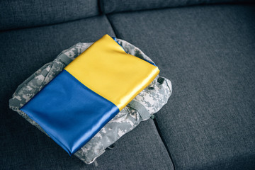 ukrainian flag and military clothing on couch at home