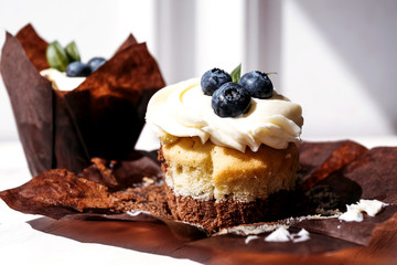 Berry cupcakes with filling. Dessert for birthday, wedding, celebration. Decoration in chocolate tone.