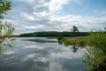 beautiful summer lake against the background of high mountains and blue sky
