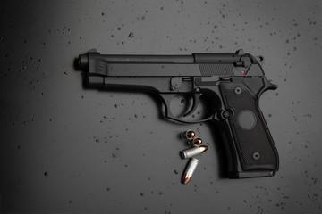 Modern black gun on a dark background. Pistol