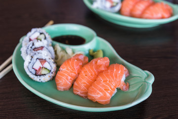 A small sushi plate with nigiri and maki sushi