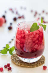 Red drink with ice and lemon balm