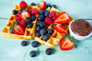 sweet belgian waffles with berries and chocolate cream
