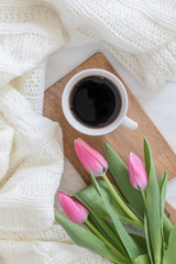 coffee and tulips with a soft blanket flat lay seen from above