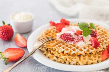 Waffles with strawberries and cream