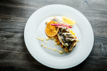 top view of delicious sea fish on pickled pepper garnish