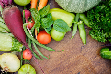 Fresh Harvest from the Gardens on Wooden chalkboard from above. Carrot, tomato, pepper, cucumber, onion, zucchini, radish, parsley.