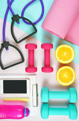 Naklejka premium Health and fitness concept flatlay with exercise equipment on modern colorful background.