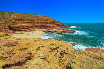 Scenic aerial view of Pot Alley in Kalbarri National Park, Western Australia from Pot Alley lookout. Rugged sandstone, Coral coast in turquoise Indian Ocean. Blue sky with copy space.