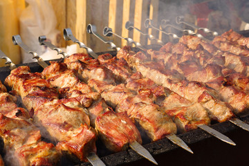Barbecue. Cooking street food. The meat is fried over an open fire.