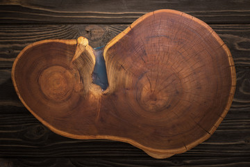 top view of wooden cutting board on brown table