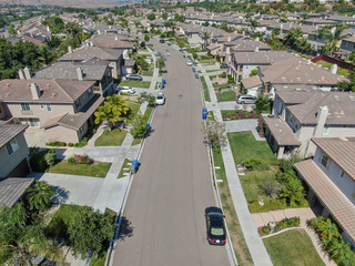 Suburban neighborhood street with big villas next to each other in Black Mountain, San Diego,...