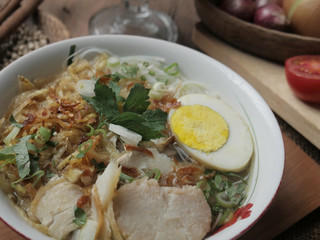 Indonesian chicken soto or soto ayam, served with ketupat or lontong