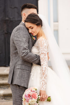 Wedding couple. Beautiful bride and elegant groom in love at wedding day. Stylish newlywed couple. Marriage concept