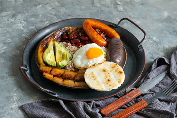 Colombian food. Bandeja paisa, typical dish at the Antioquia region of Colombia - chicharrón...