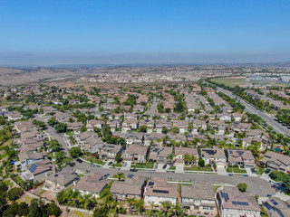 Obraz premium Aerial view suburban neighborhood with big villas next to each other in Black Mountain, San Diego, California, USA. Aerial view of residential modern subdivision luxury house.
