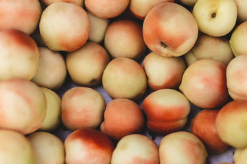 A lot of peaches in box on sale at farms market. peaches background. selective focus