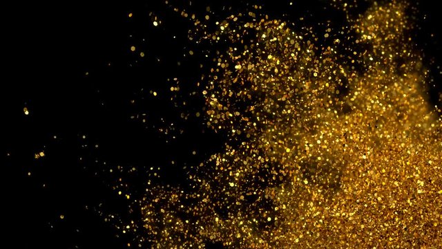 Abstract Golden glitter explosion in slow motion Bokeh background with shining defocus blurred sparkles dust macro close up with alpha channel