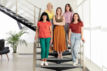 Group of ladies on stairs indoors. Women power