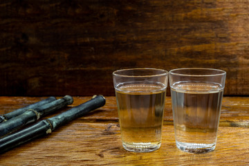 Several glasses of brazilian cachaça isolated on rustic wooden background, variations and types of brazil cachaça, typical drink from brazil.