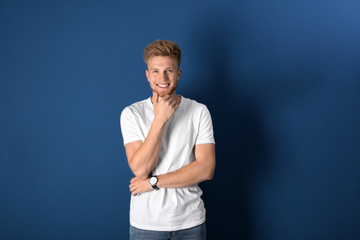 Portrait of handsome young man on blue background