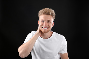 Portrait of handsome young man on black background