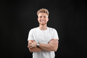 Portrait of handsome young man on black background