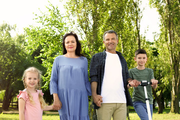 Couple of pensioners with grandchildren in park