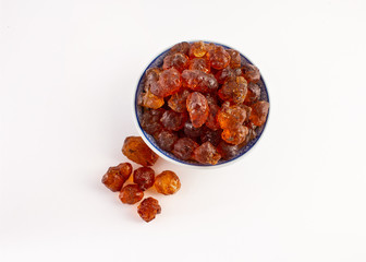 group of peach gum in plate on white background..