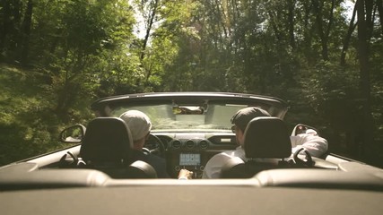 Caucasian Gay Couple Friends on the Road Trip in the Modern Convertible Vehicle. - Powered by Adobe