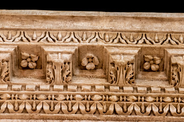 Intricate hand carved Roman patterns from an overhang