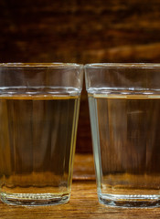 glasses of brazilian cachaça isolated on rustic wooden background. It is used in the preparation of the worldwide known cocktail caipirinha. traditional drink from brazil