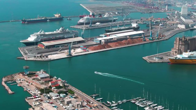 Drone view of beautiful huge commercial port with boats and yachs at sea.