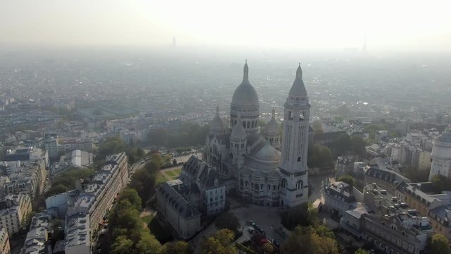 Aerial: Sacre-Cur Church in Paris, France with City Spread Out Beneath
