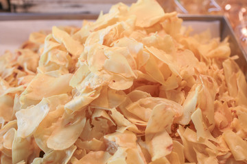 Heap of fried Durian chips is sold in local Thai market. Traditional crispy Thai dessert dry Durian.