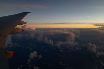 Fototapeta na wymiar A beautiful sunset as seen through the window of an aeroplane