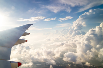 Fototapeta premium Blue skies and sun, as seen through an aircraft window in flight