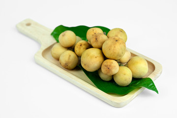 LongKong is placed on a wooden tray. Tropical fruit, Langsat, lanzones, Lansium parasiticum on a white background. - Image