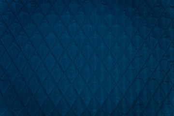 Quilted fabric. The texture of the blanket.