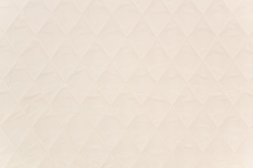 Quilted fabric. The texture of the blanket.