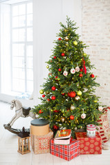 Classic Christmass or New Year decoration in a bedroom. Toy horse, spruce, classic decorations....