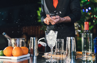 Professional male bartender crushed ice prepare mixing cocktail drink at village night party celebration, Extra work job service customer outdoor people lifestyle.