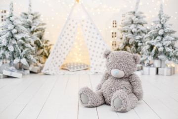 White stylish interior with little Christmas tree trees and children play wigwam  © Olga Mishyna