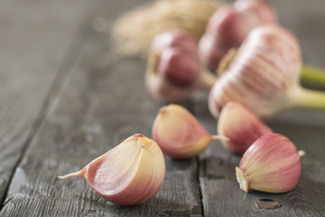 Raw garlic on a black rustic table. Component of traditional medicine.