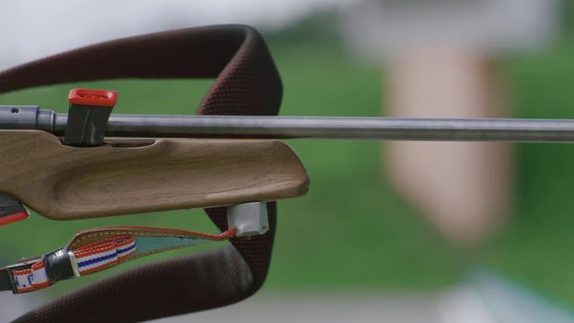 Portrait of Caucasian female professional biathlete practicing on a shooting range during mid-season practice in summer. ARRI Alexa Mini with Cooke S4 prime lenses RAW graded footage