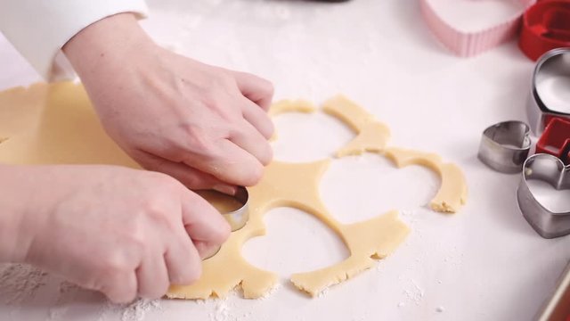 Step by step. Cutting out shapes from sugar cookie dough with cookie cutters.