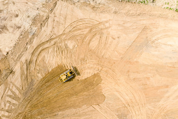 aerial top view of yellow industrial bulldozer working at construction site © Mr Twister